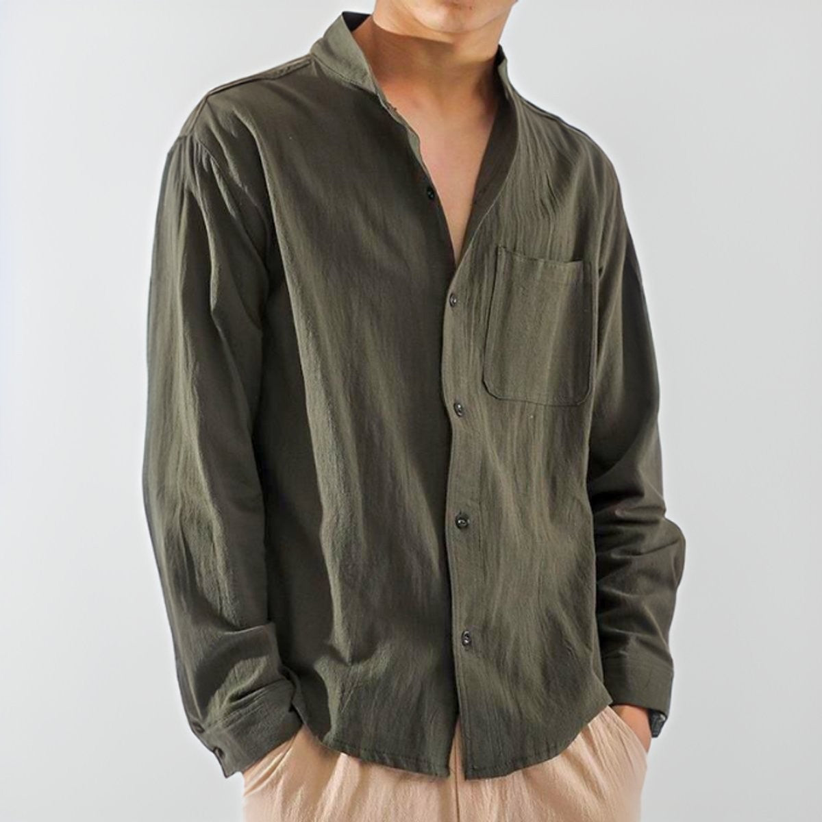 Olive cotton henley shirt with stand collar and chest pocket, worn open-necked