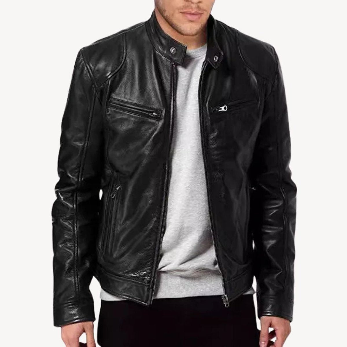 Model wearing black leather biker jacket over grey sweatshirt