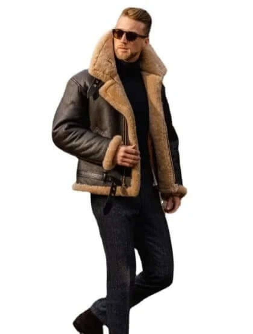 Model in brown leather shearling bomber jacket with tan fur collar and jeans