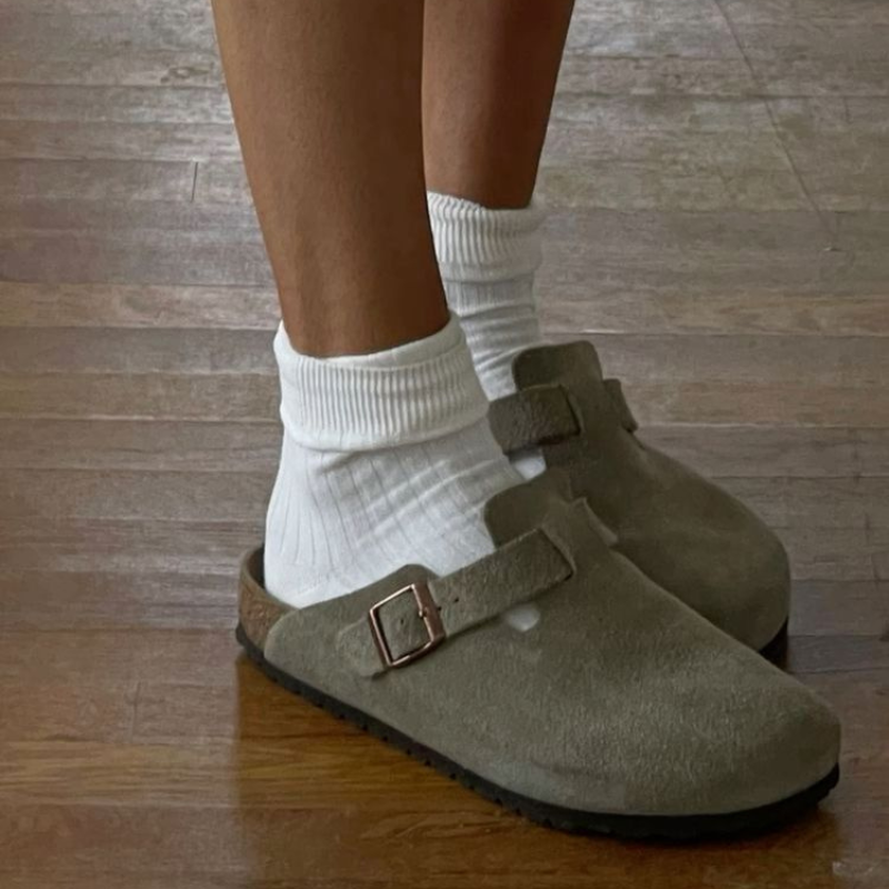 Khaki suede buckle clogs worn with white ribbed socks