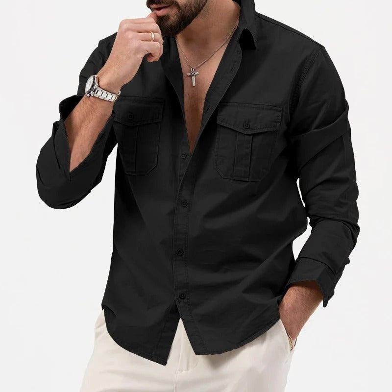 Black long-sleeved utility shirt with flap chest pockets, casually worn