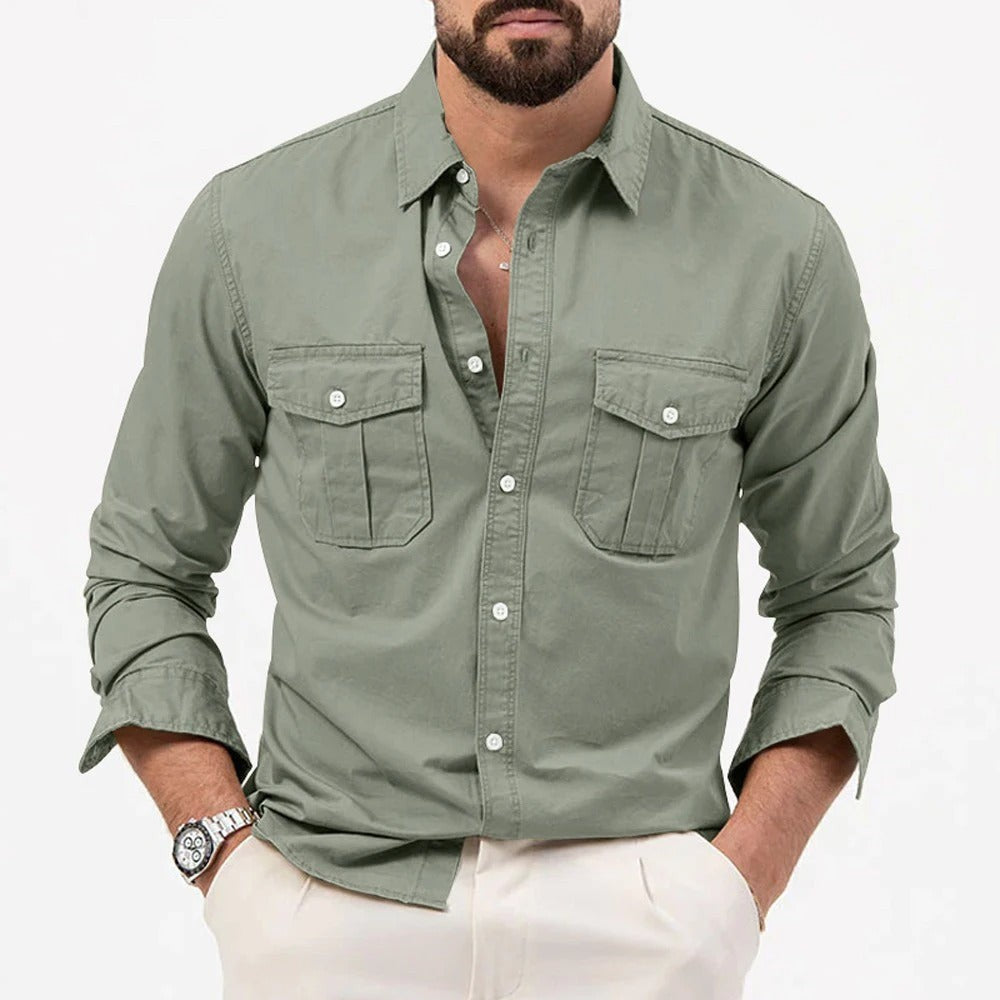 Sage green long-sleeved shirt showing turned-up cuffs and flap pockets