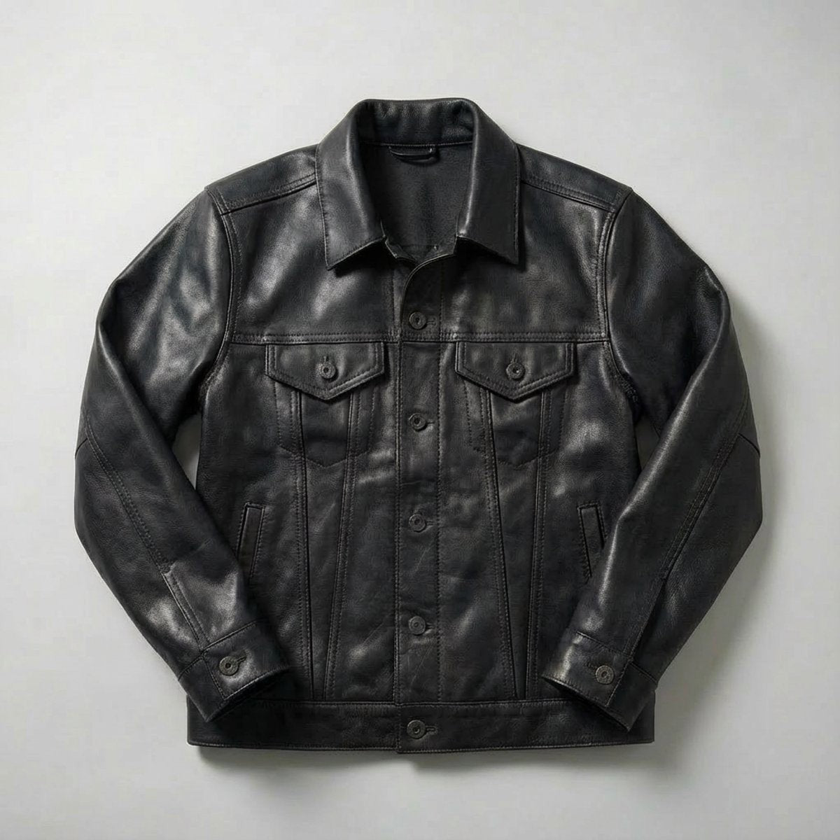 Black full-grain leather trucker coat with button-front and flap chest pockets