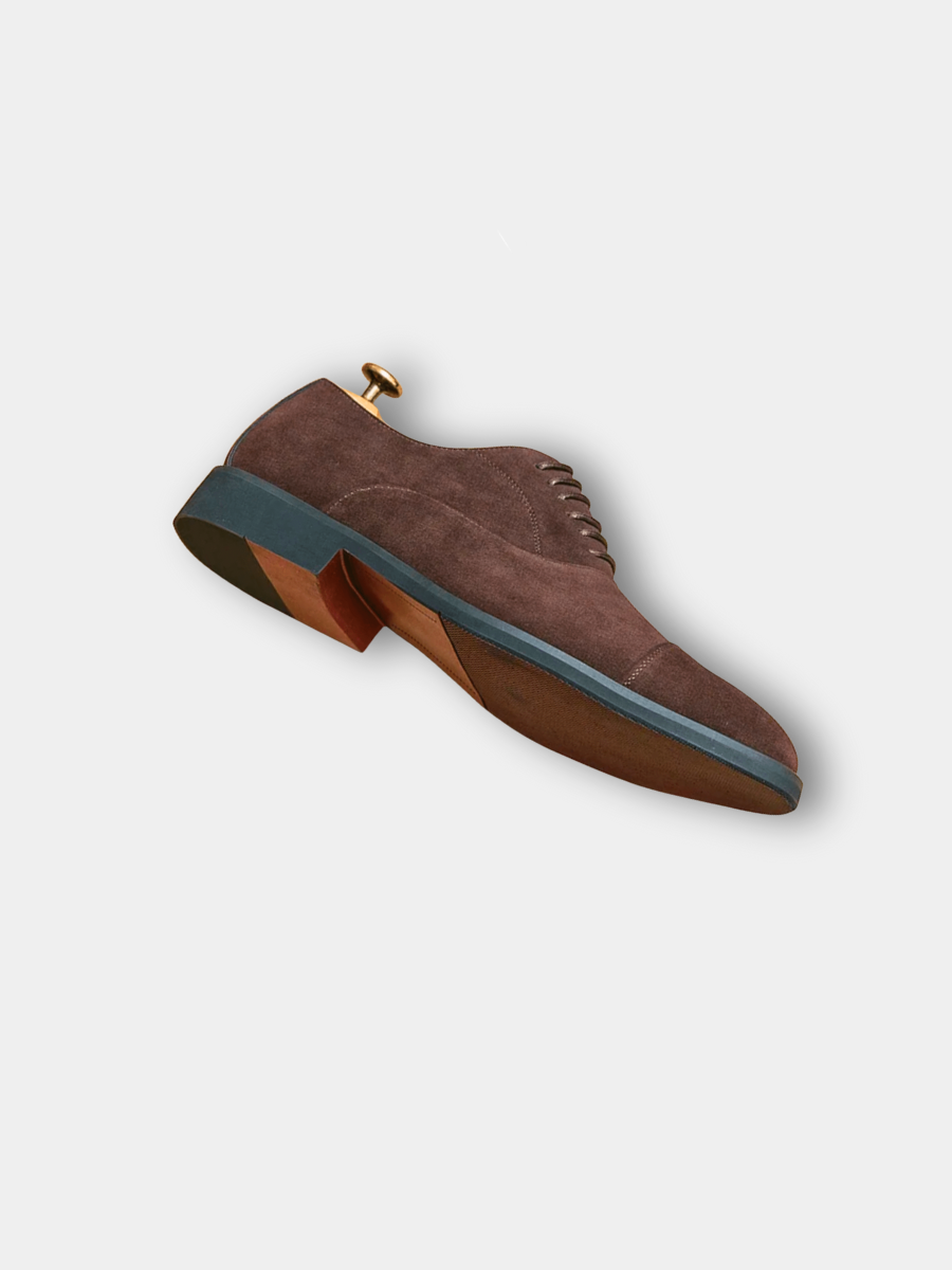 Sole view of brown suede Oxford shoe with contrast blue and tan sole