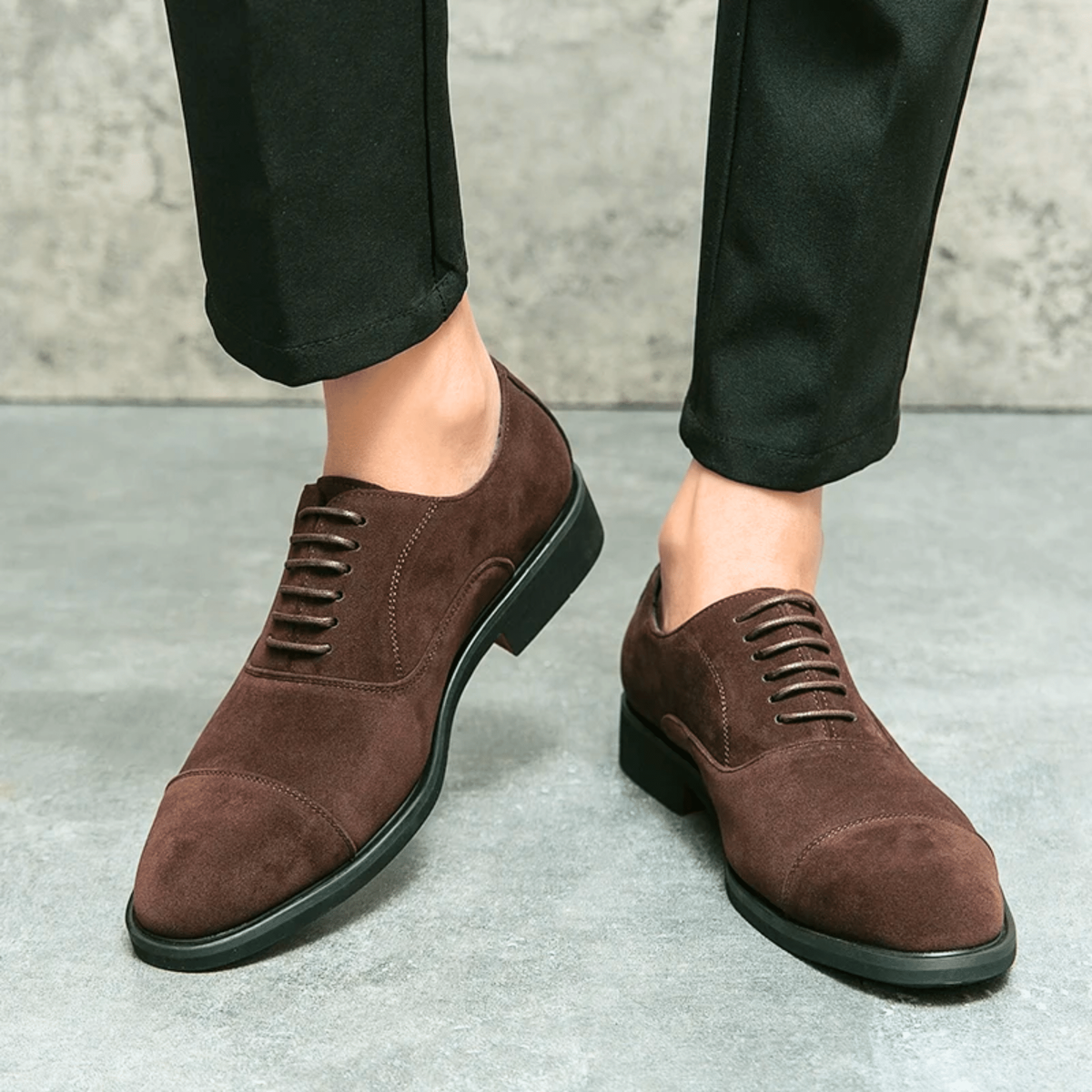 Man wearing brown suede lace-up shoes with black tailored trousers