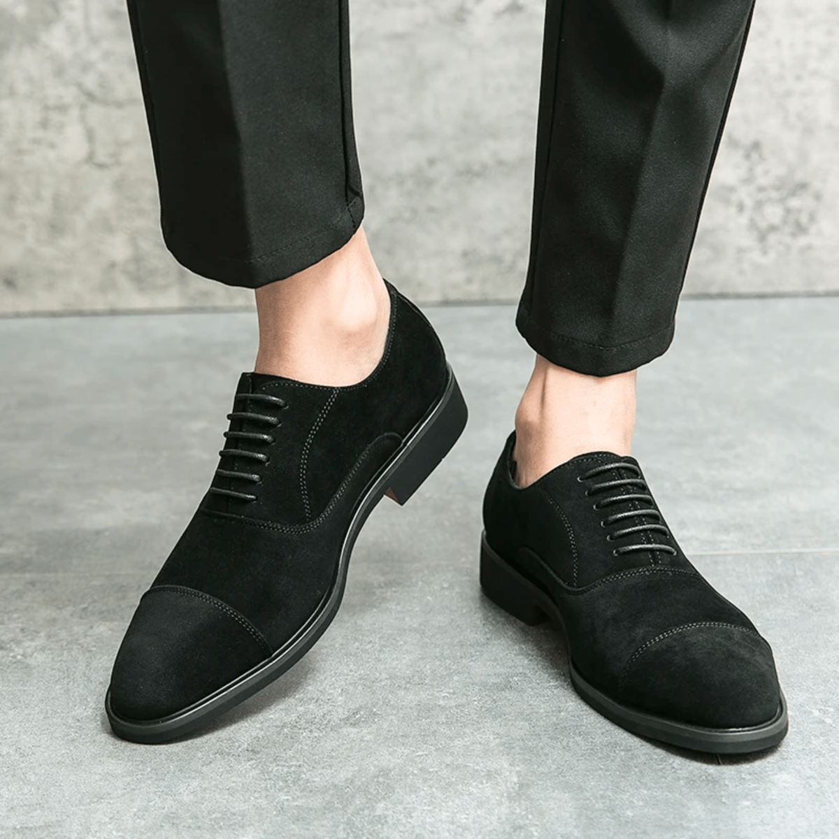 Man wearing black suede lace-up Oxford shoes with tapered trousers