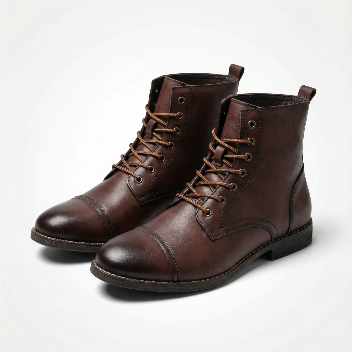 Pair of dark brown leather ankle boots with tan laces