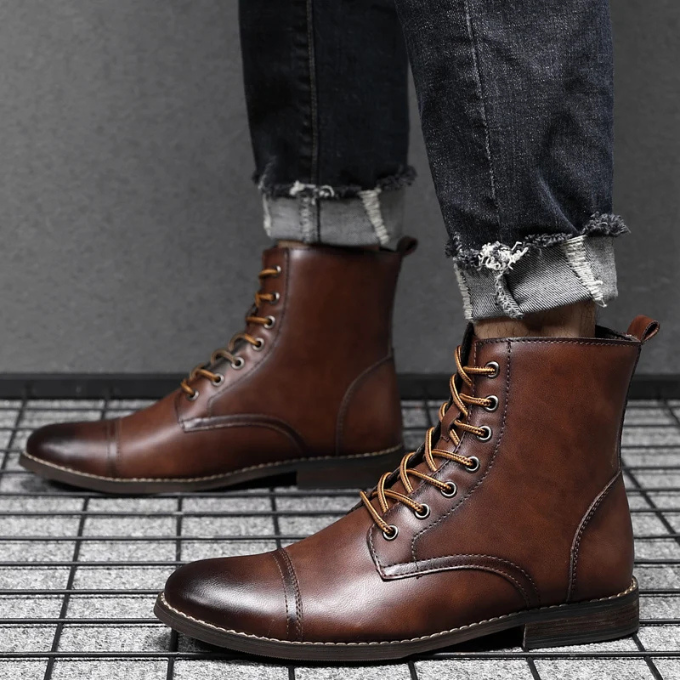 Side view of brown leather ankle boots worn with rolled denim