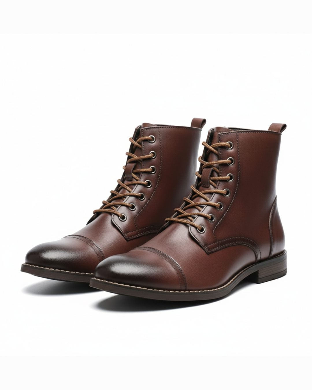 Pair of brown leather cap-toe boots with tan laces on white background