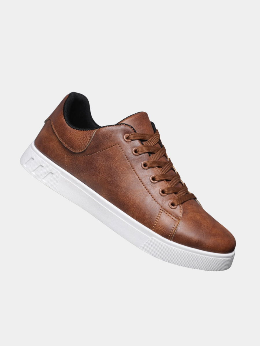 Tan leather trainers with white soles and contrasting lace-up fastening