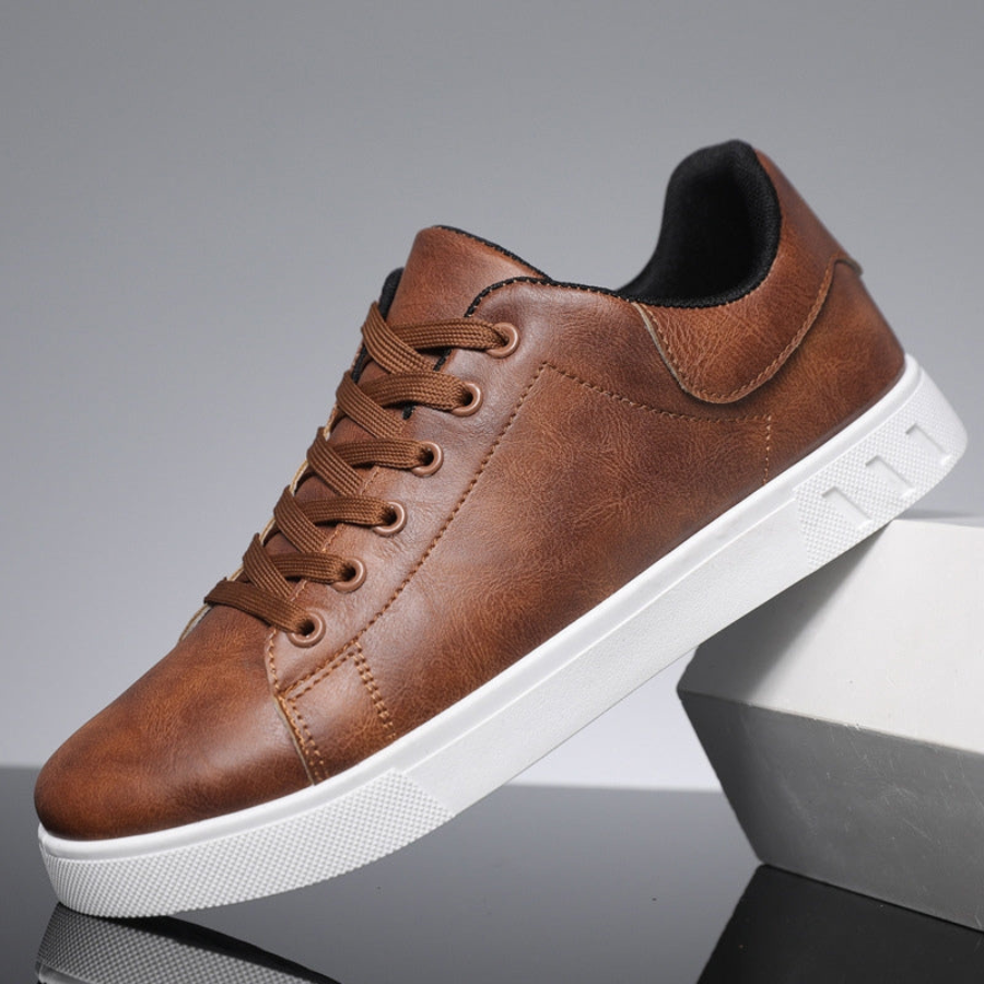 Brown leather trainer showing lace detail and chunky white sole