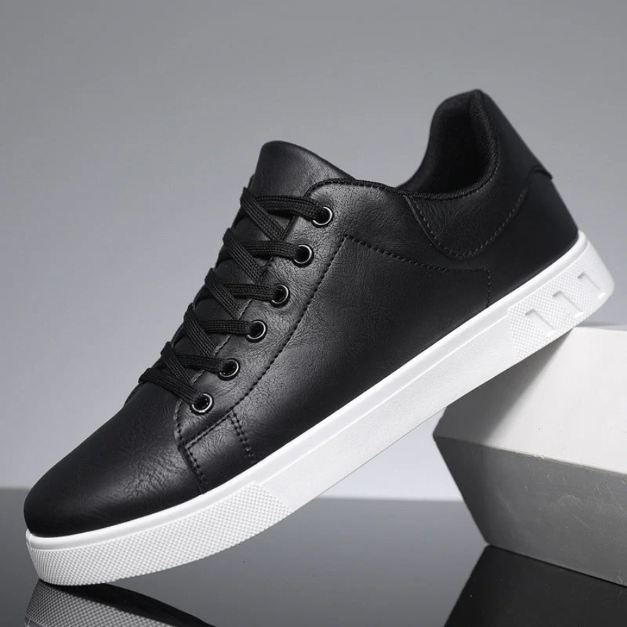 Black leather trainer with white sole and lace-up front
