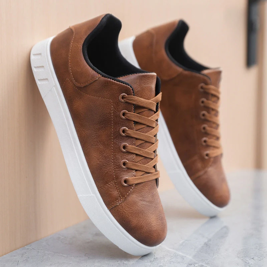 Brown leather trainers leaning against wall with black heel lining