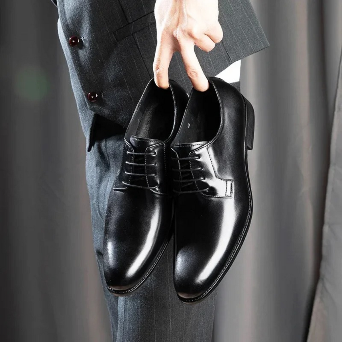 Black leather lace-up Derby dress shoes with round toe and glossy finish