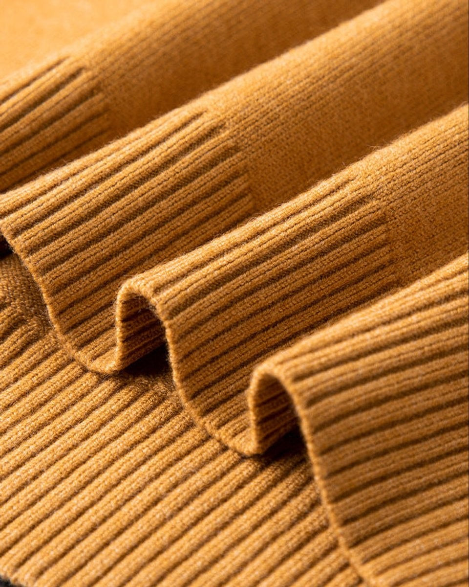 Close-up of ribbed cuff detail on a mustard cashmere blend jumper
