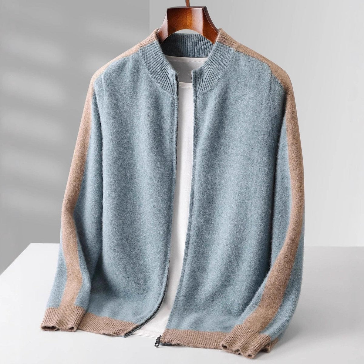 Pale blue knitted zip cardigan featuring camel contrast sleeves and ribbed cuffs