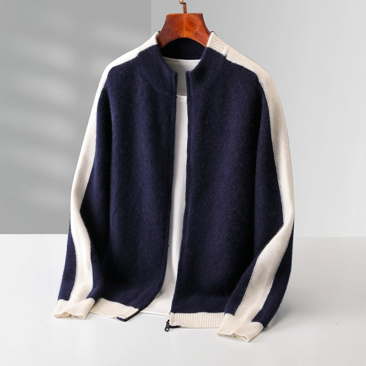 Navy zip-up knit cardigan with cream contrast stripe down the sleeves