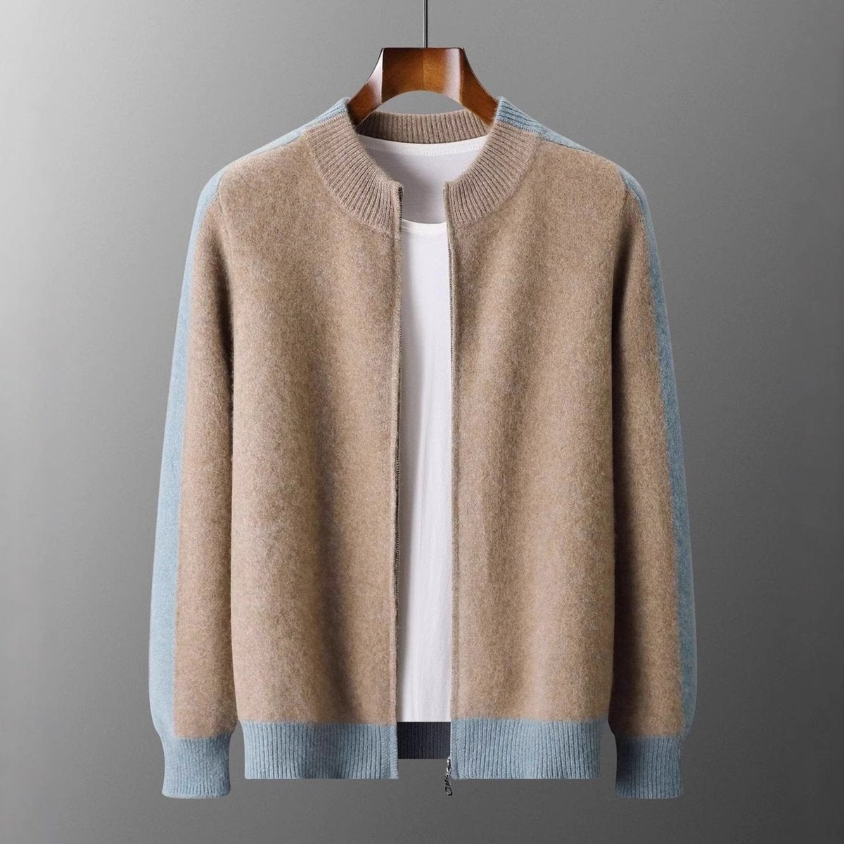 Camel cashmere zip cardigan folded neatly beside a classic leather watch