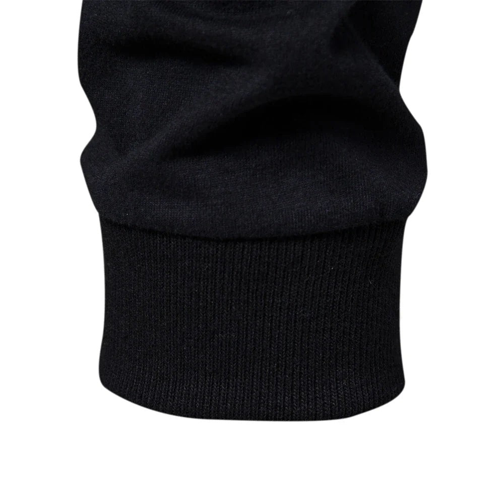 Close-up of ribbed cuff detail on black long sleeve top