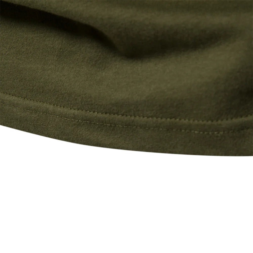 Close-up of hemline stitching on khaki green long sleeve shirt