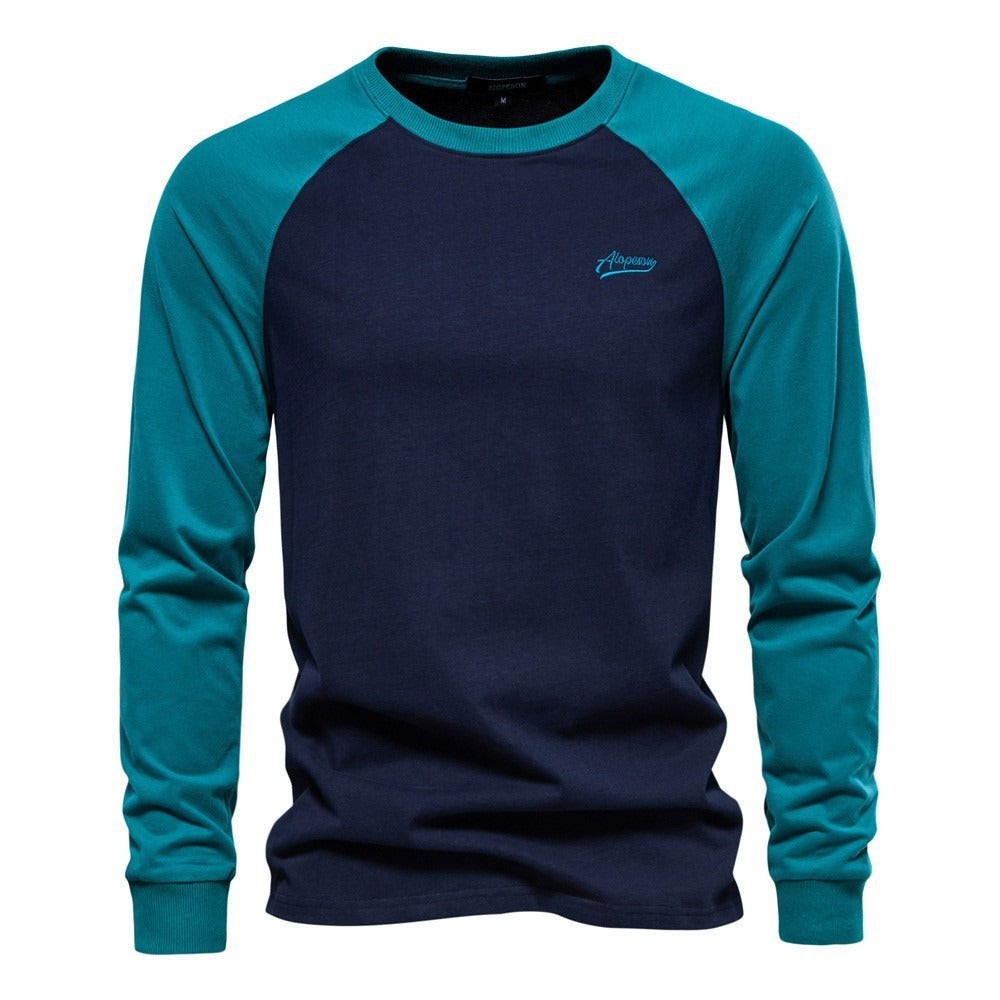 Navy raglan top with teal contrast sleeves and embroidered chest logo