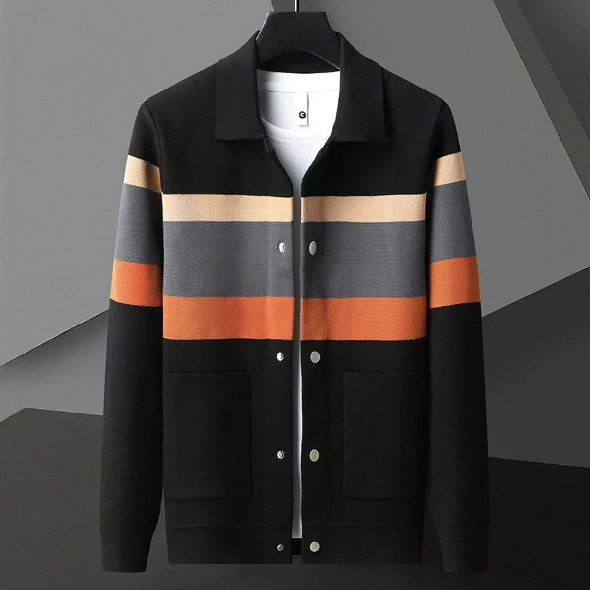 Black knit cardigan jacket featuring orange and grey striped colour-block panel