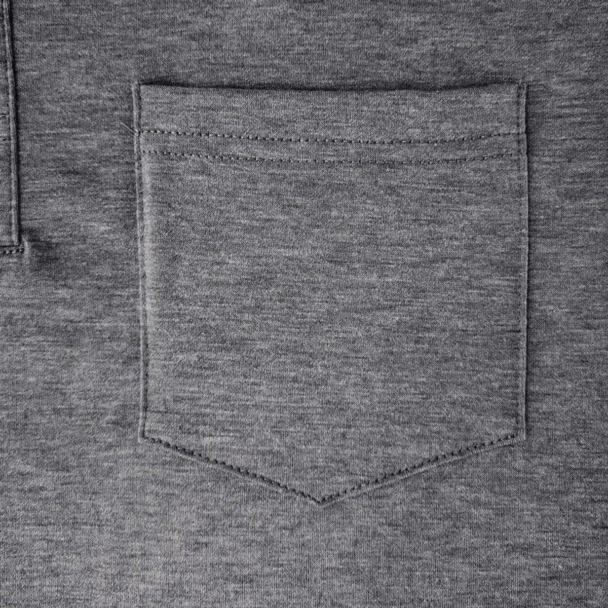 Close-up of grey polo shirt chest pocket showing stitched detailing