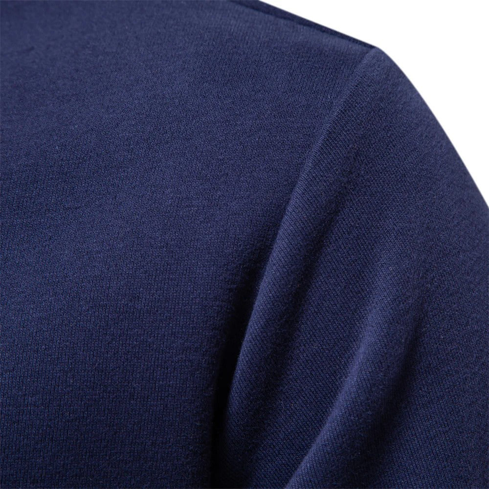 Close-up of navy sweatshirt fabric showing ribbed shoulder seam