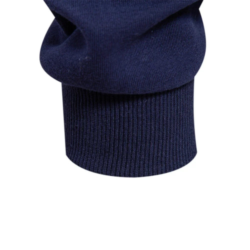 Close-up of ribbed cuff detail on navy sweat polo sleeve