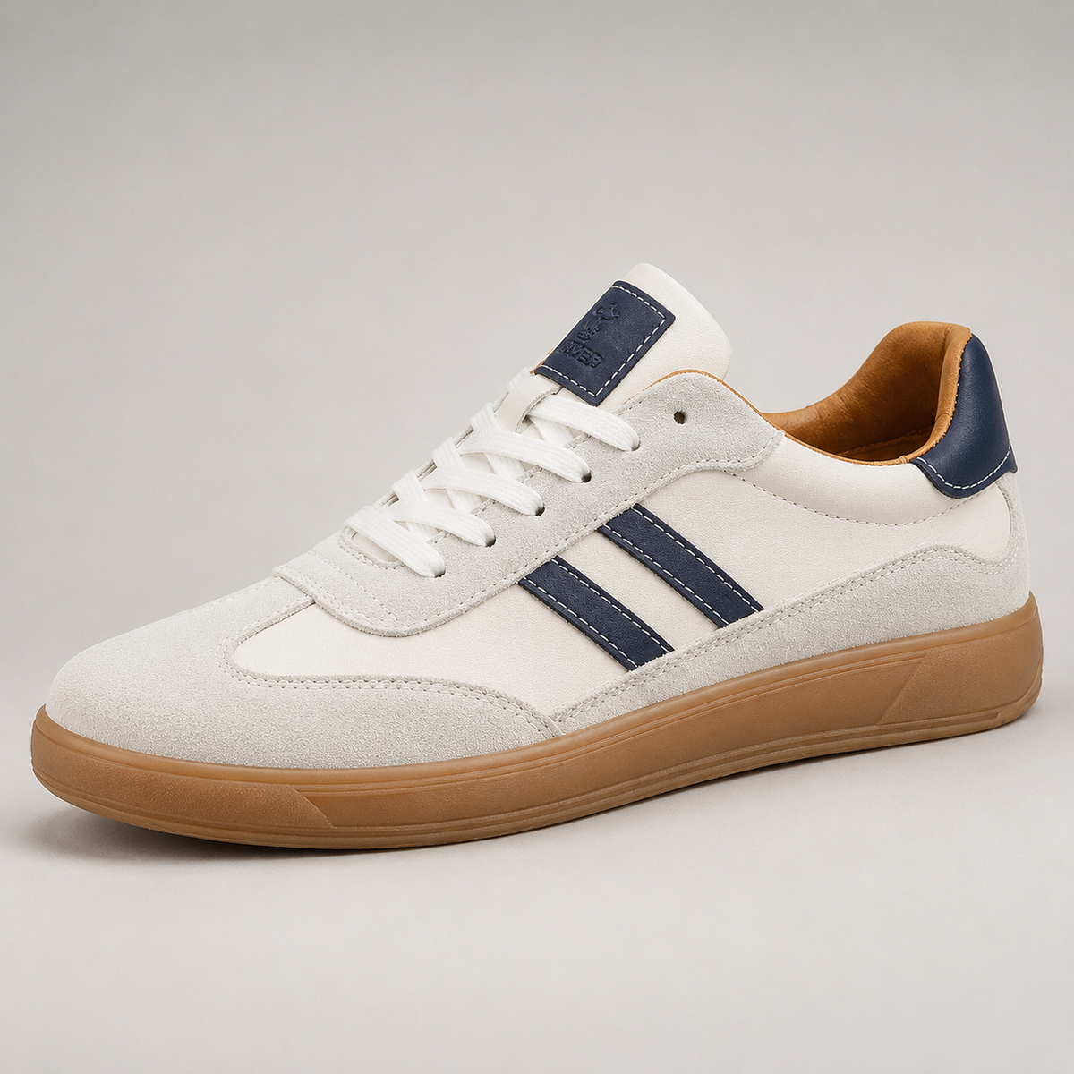 White suede trainer with navy stripes and tan lining, angled view