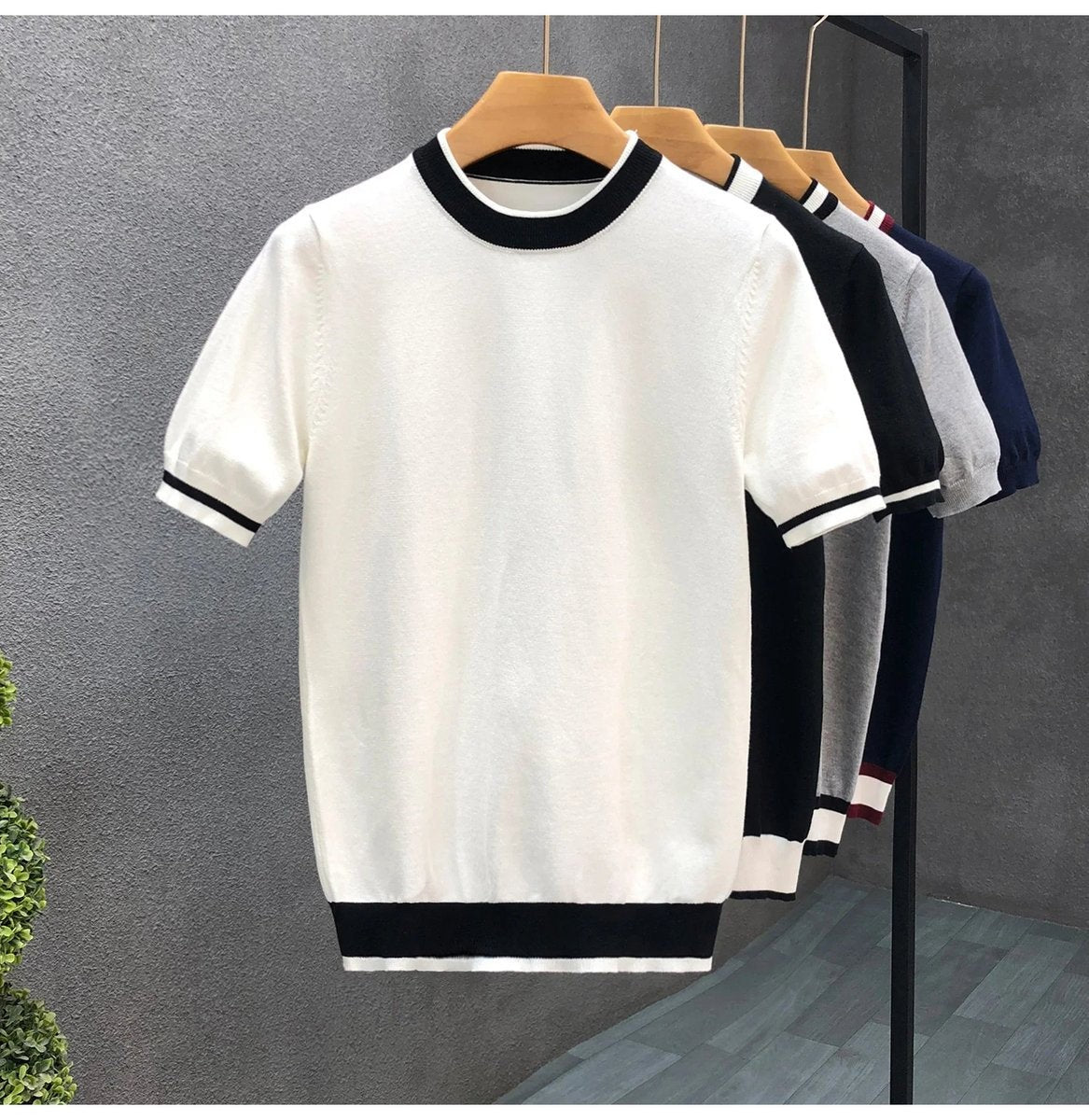 White knitted crewneck jumper with contrasting black striped hem and cuffs