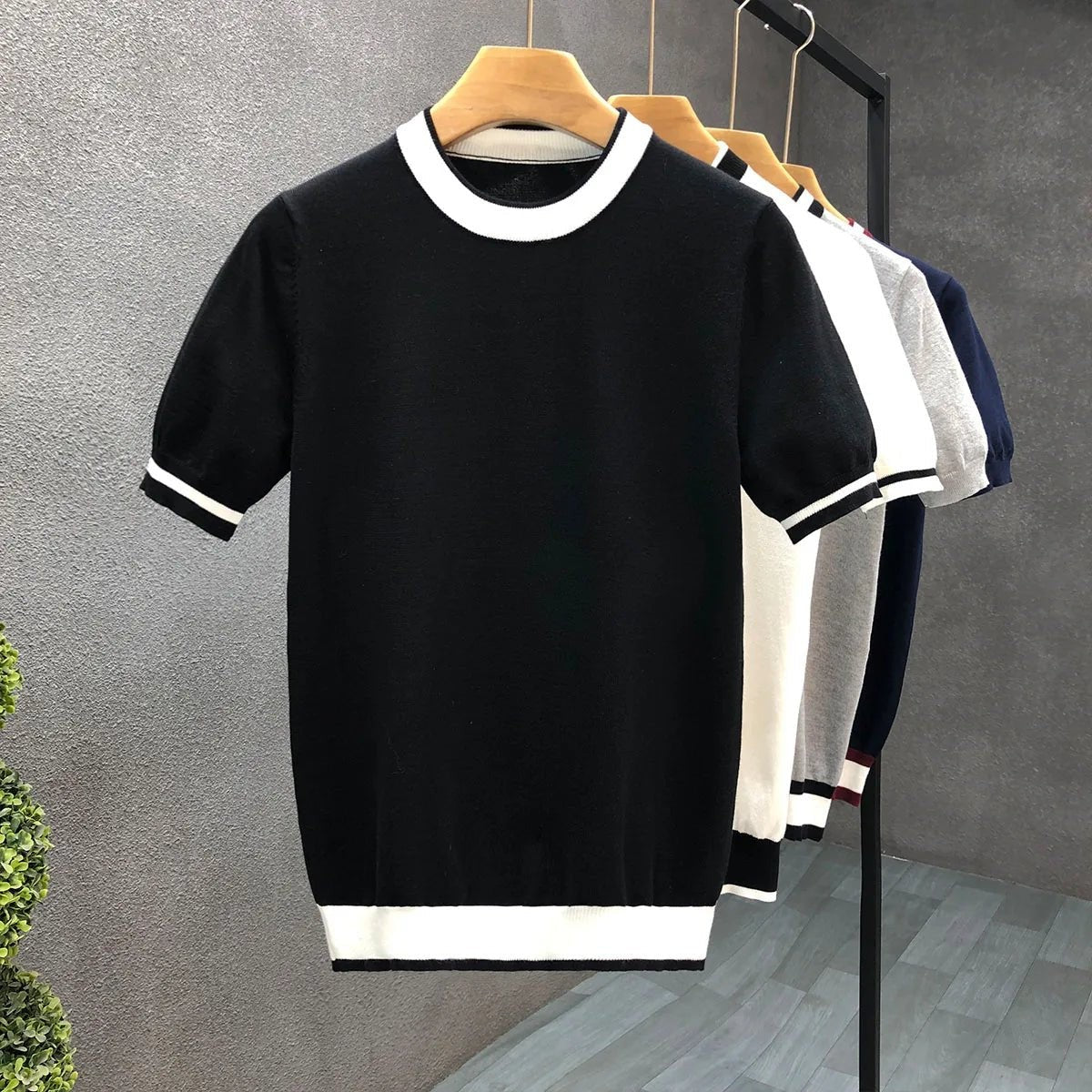 Black knitted jumper with white striped crewneck collar and ribbed cuffs