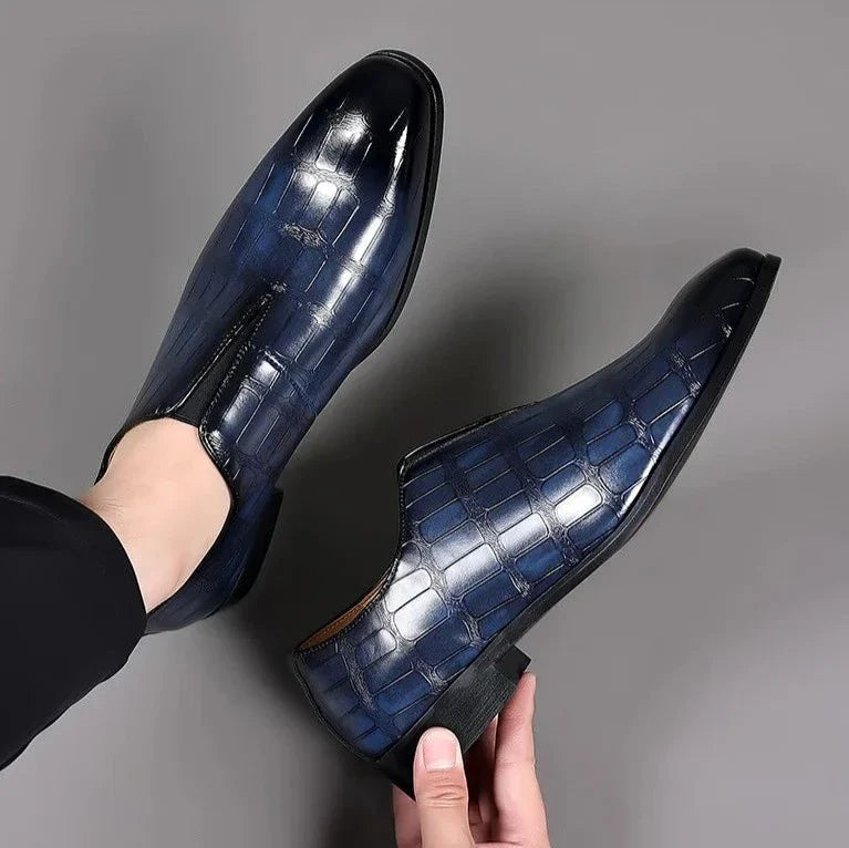 Model wearing navy crocodile-effect leather loafers with cropped trousers