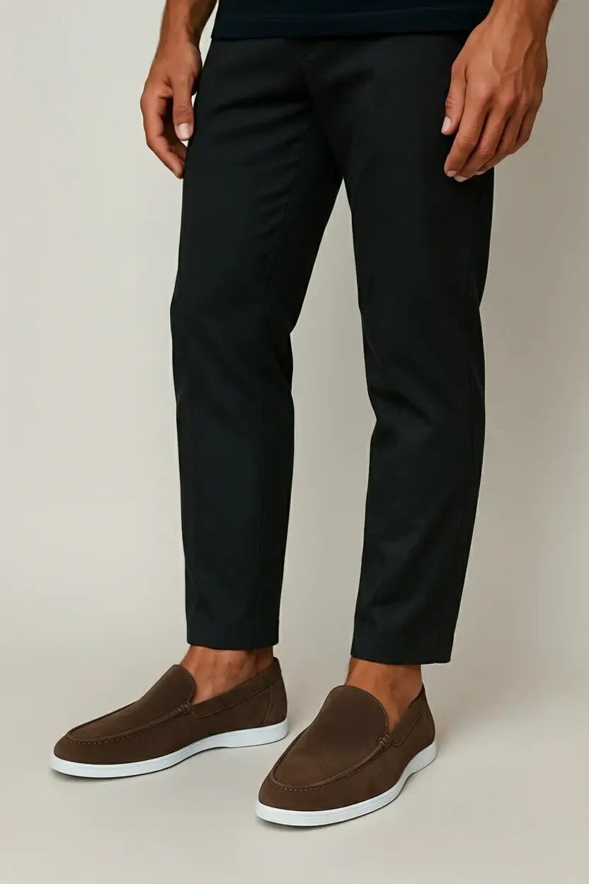 Model wearing brown suede loafers with fitted black trousers