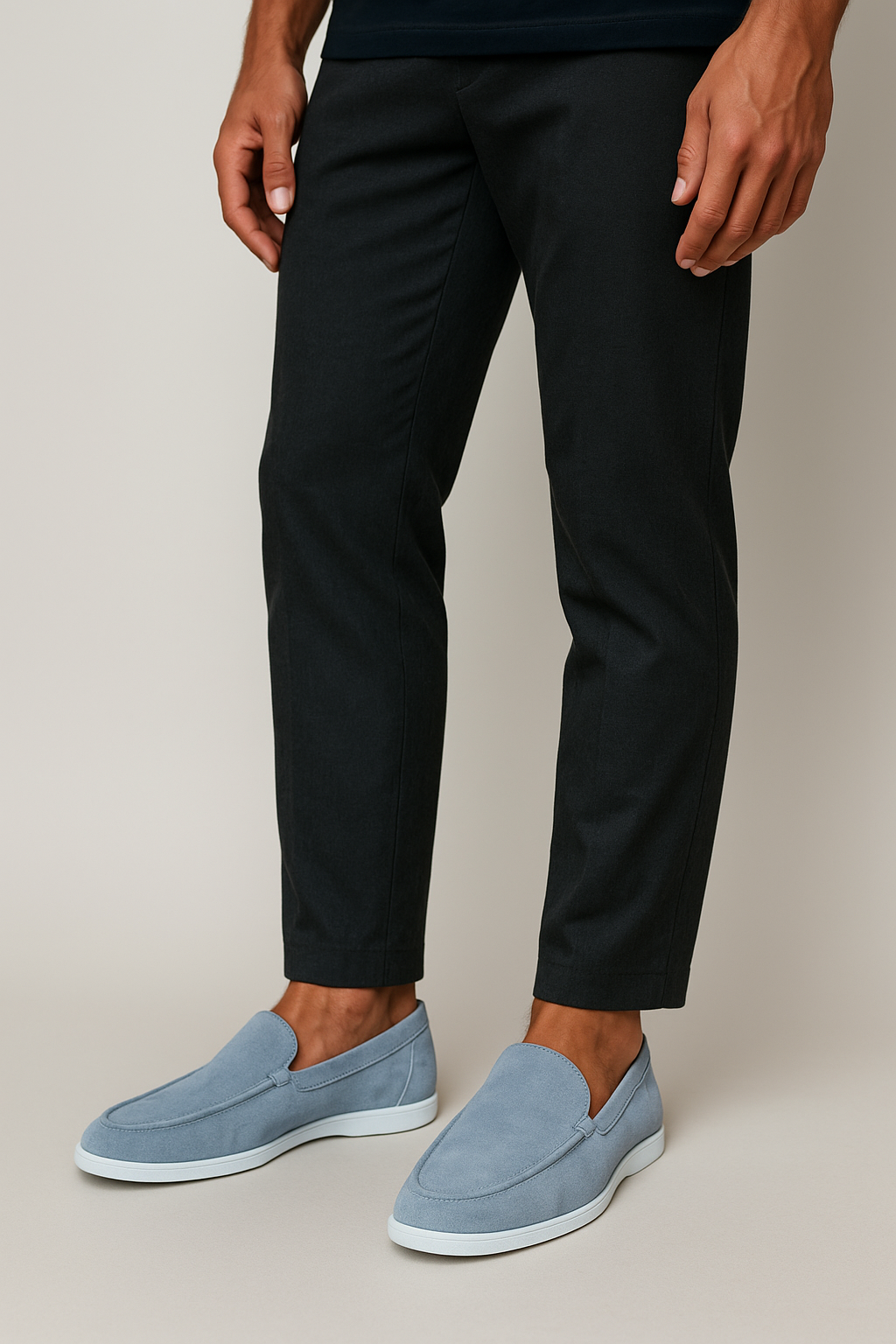 Model wearing pale blue suede loafers with matching sole and black trousers