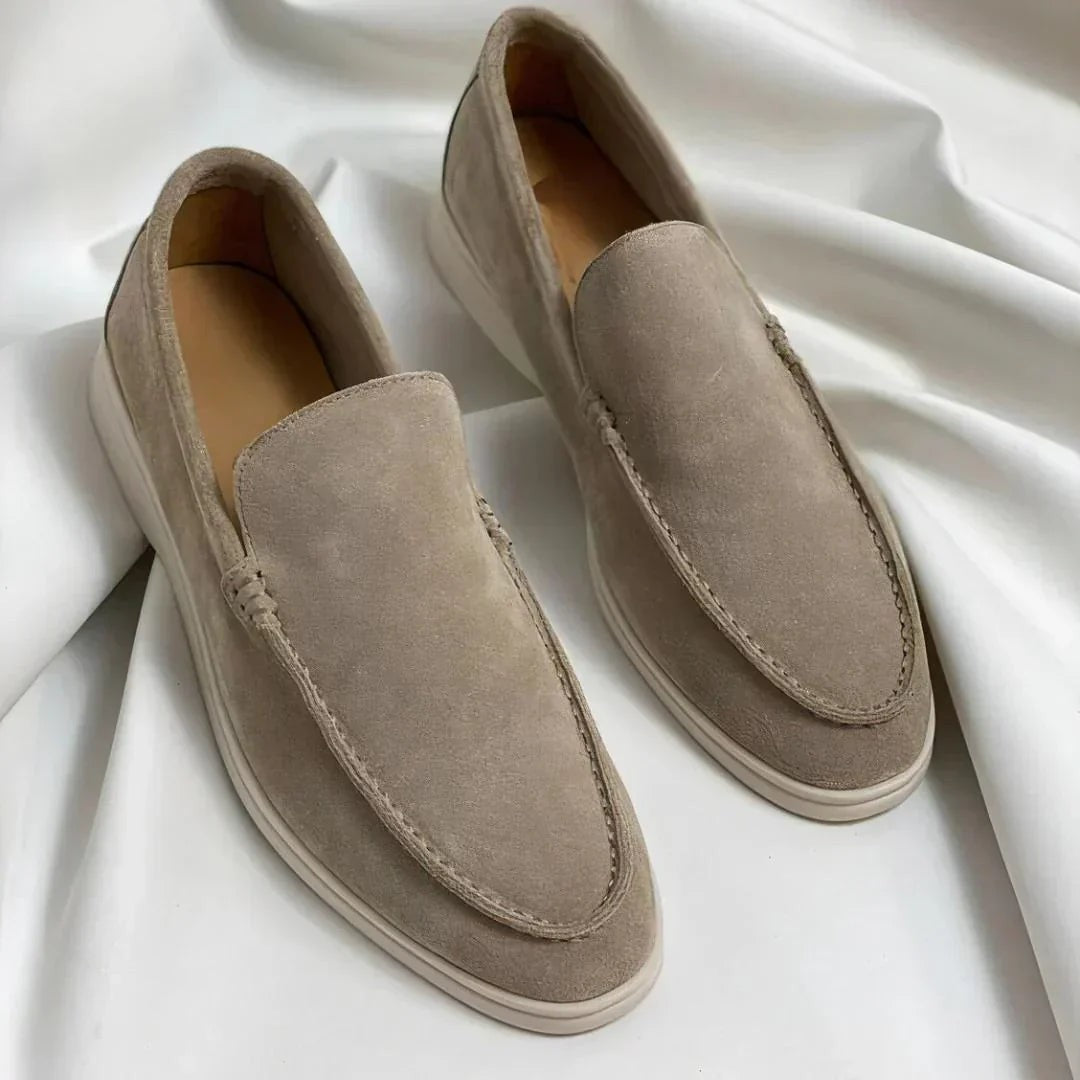 Taupe suede loafers featuring stitched apron and white sole