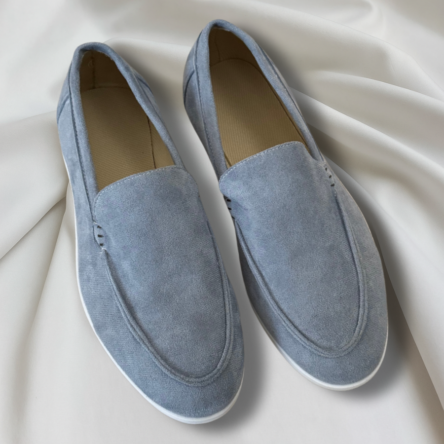 Pale blue suede loafers with white soles and round toe