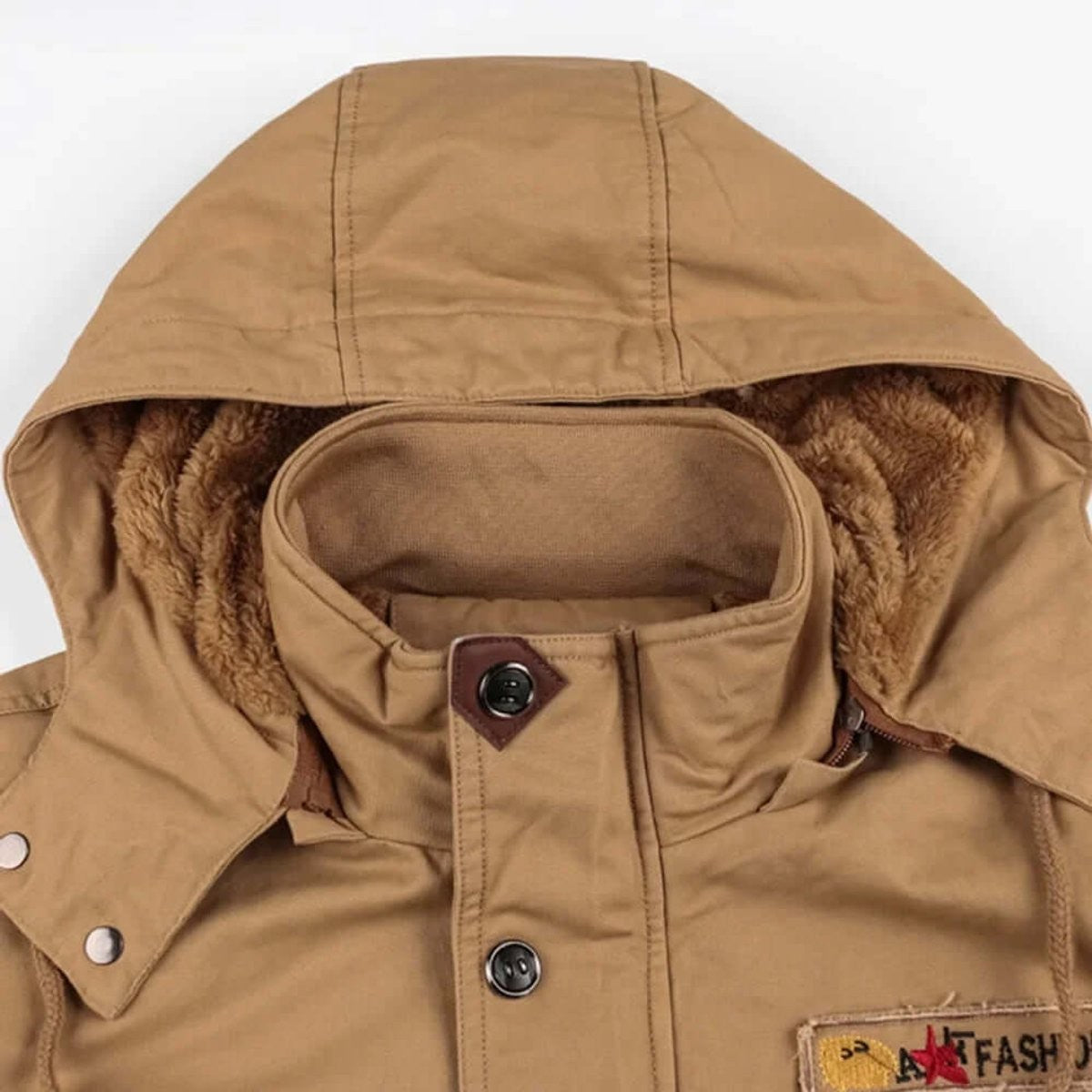 Close-up of detachable hood with fleece lining on tan winter jacket