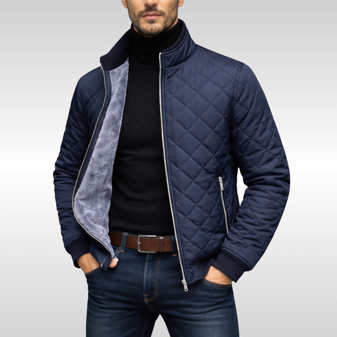 Man wearing navy diamond-quilted winter jacket over black polo neck