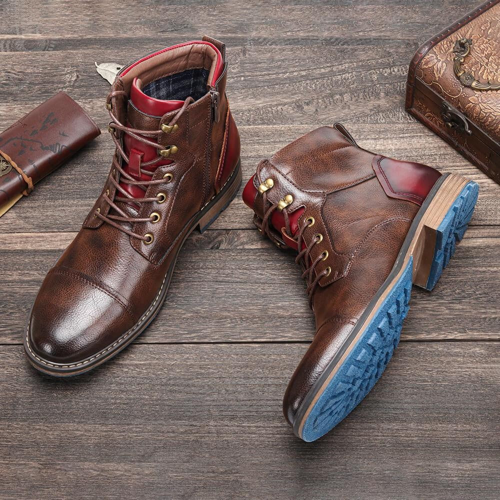 Pair of brown leather zip-up boots displaying textured tread on blue rubber sole