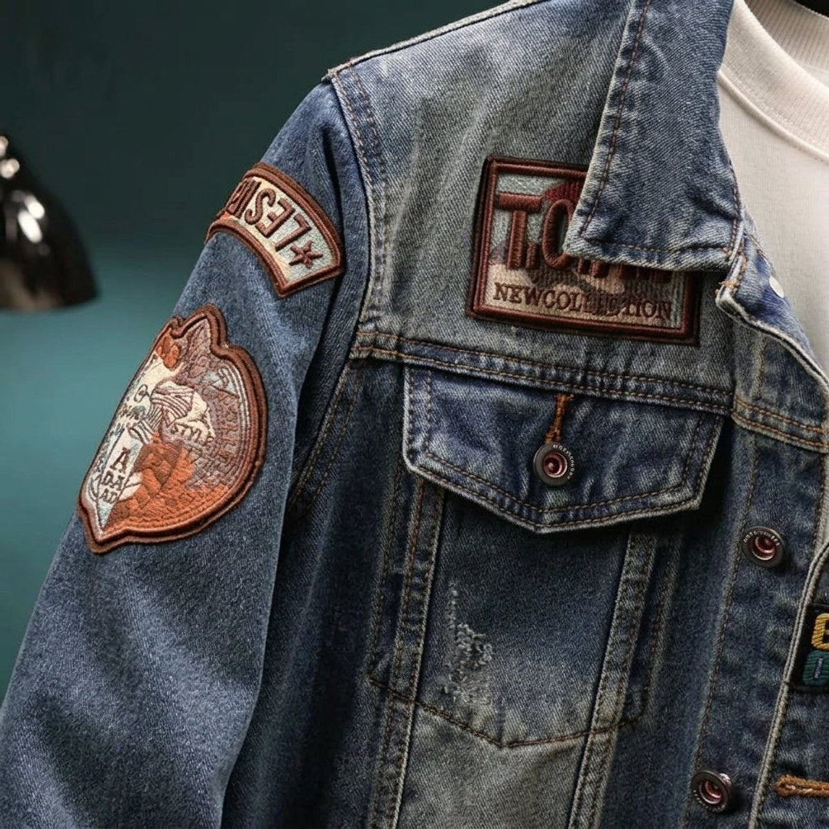 Close-up of denim jacket collar showing embroidered badge patches