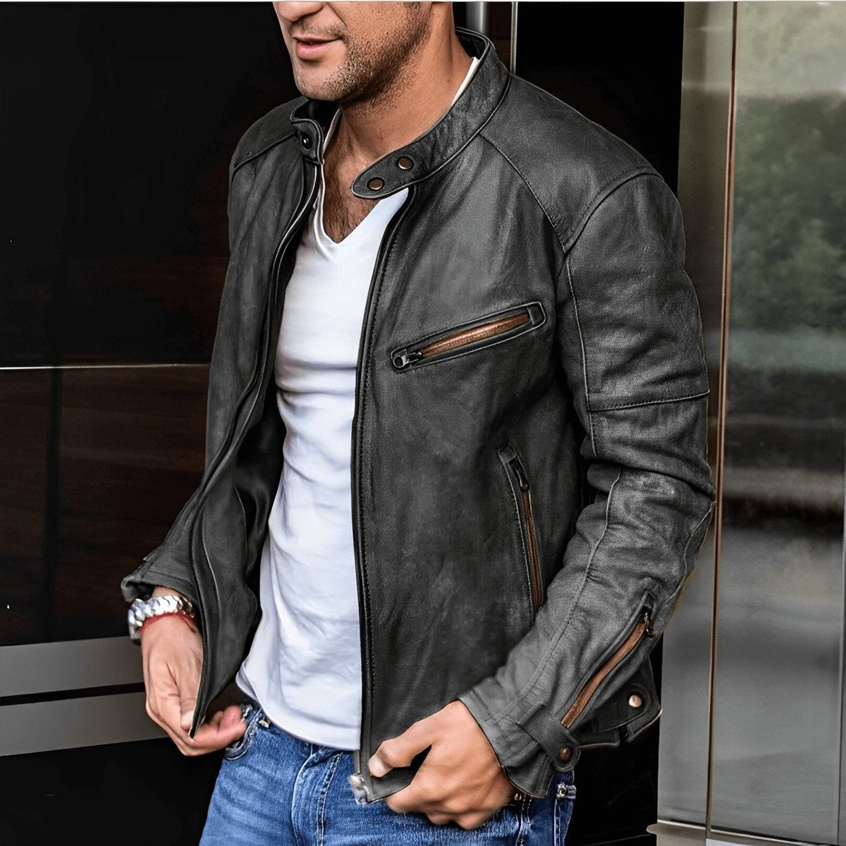 Man wearing black vintage leather biker jacket with zip-up front and stand collar