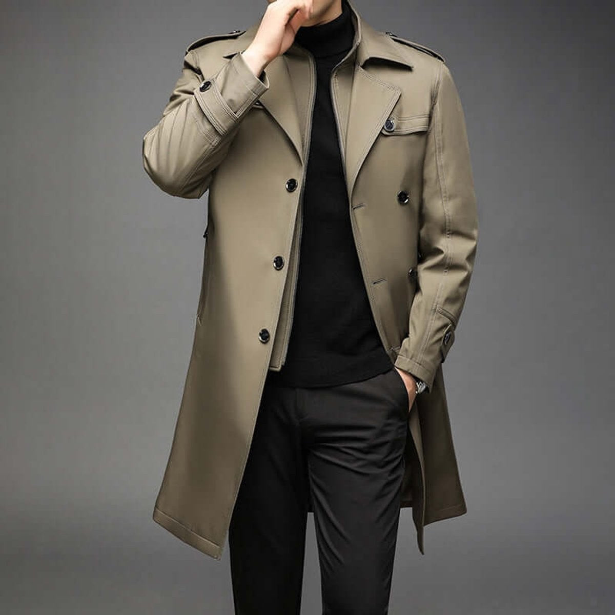 Man wearing khaki double-breasted trench coat with notched lapel and epaulettes