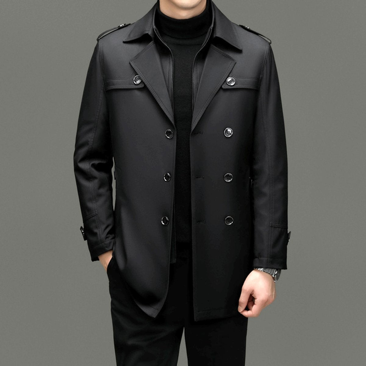 Black double-breasted trench coat worn over matching black trousers