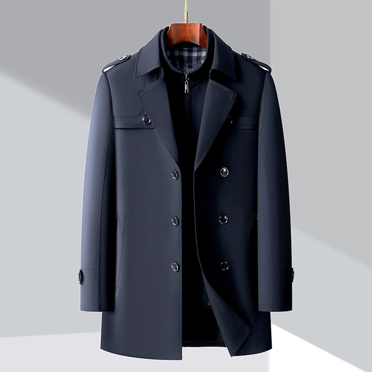 Navy double-breasted trench coat displayed on wooden hanger