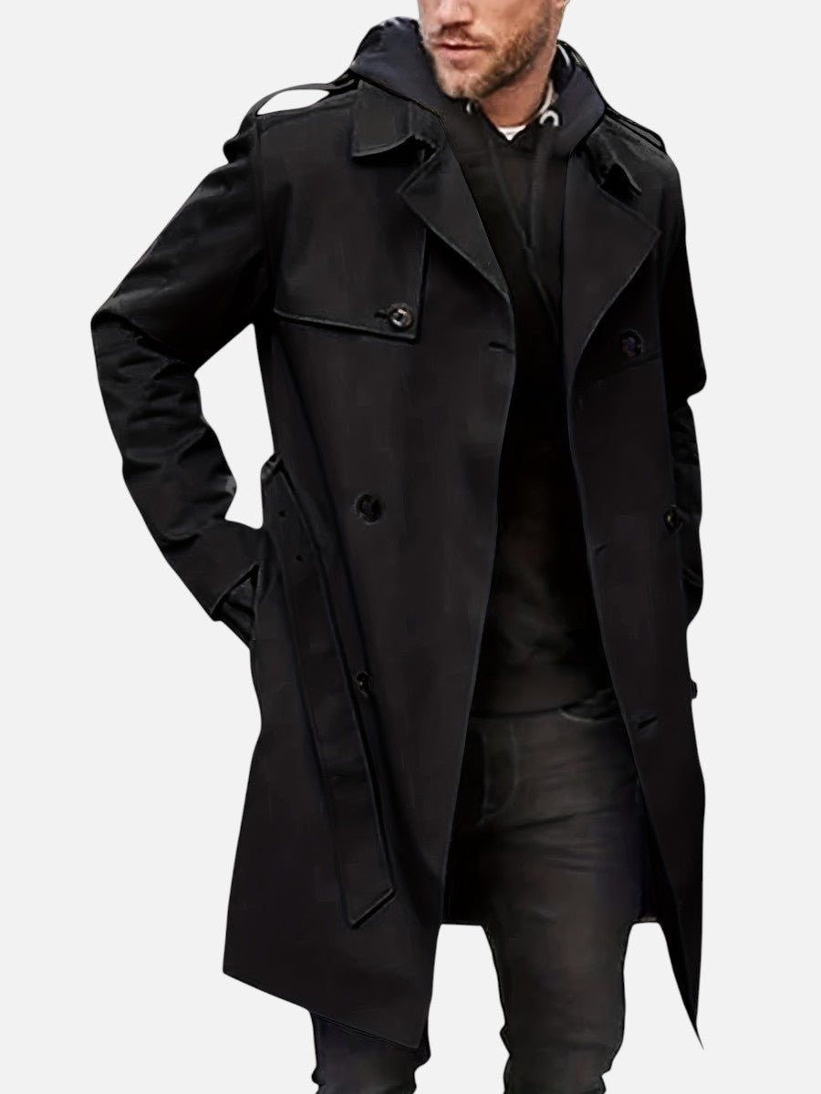 Black double-breasted trench coat styled with hoodie, front detail view
