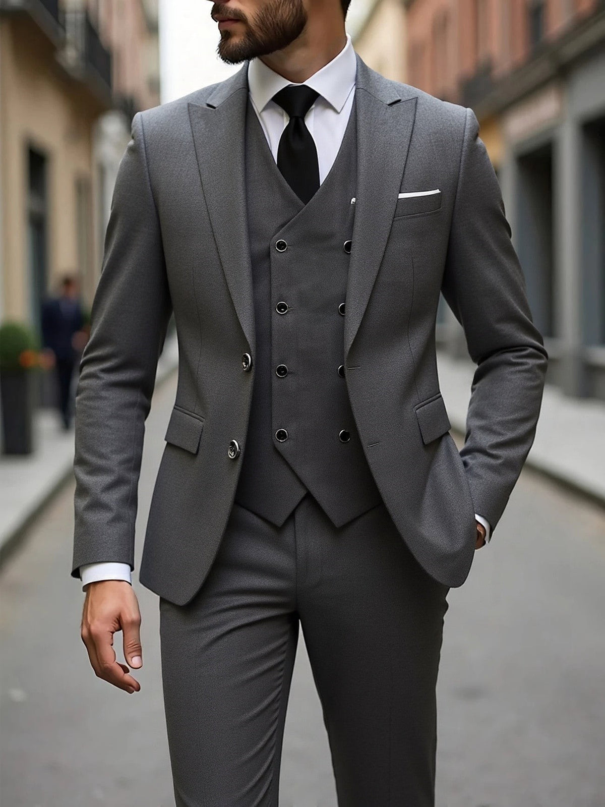 Charcoal grey three-piece suit with double-breasted waistcoat and peak lapel jacket