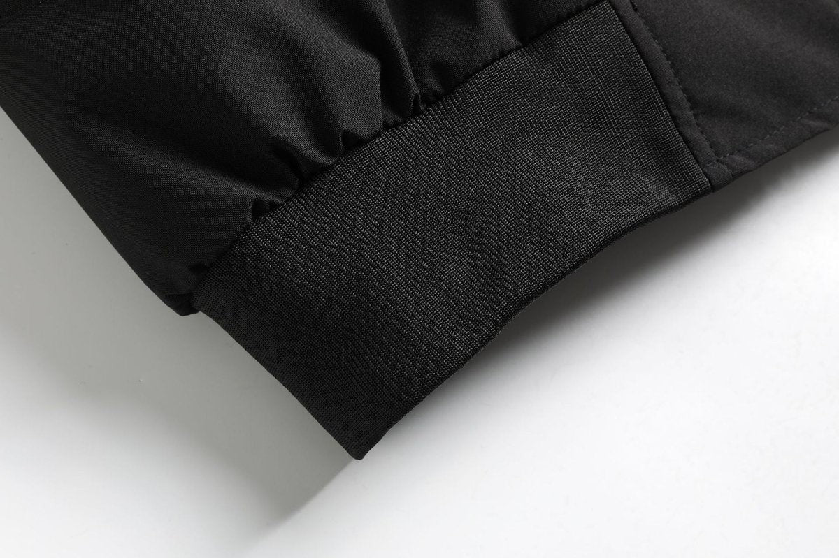 Close-up of black bomber jacket cuff and ribbed hem finish