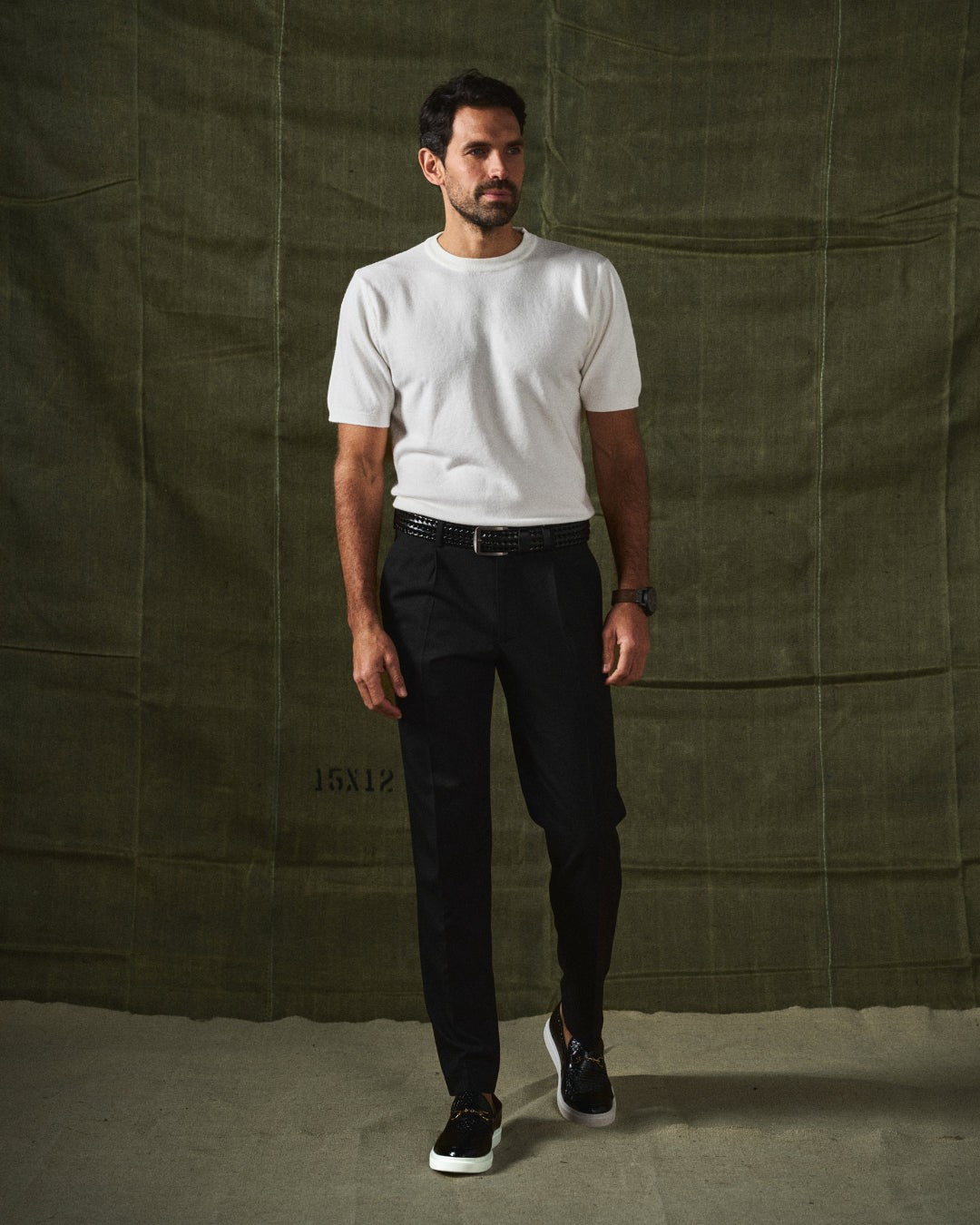 Man walking in black textured loafers with white sole and casual outfit