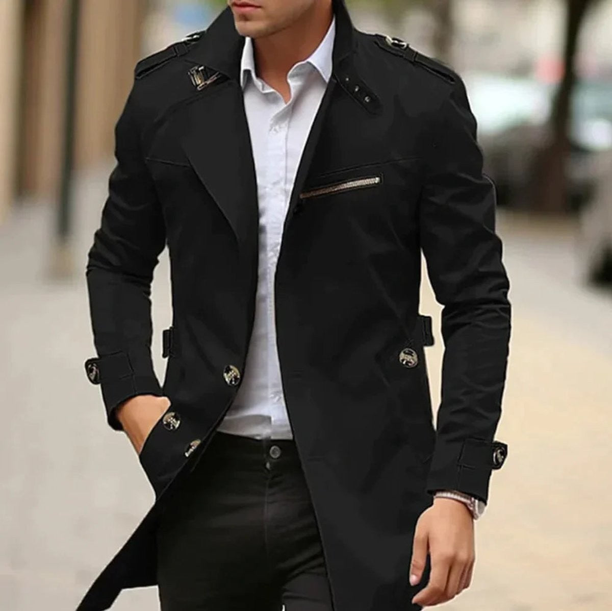 Black trench coat with shoulder straps worn over a white shirt